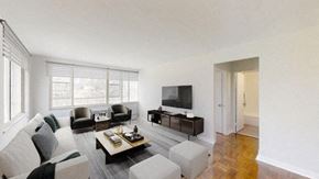 Toronto apartment for rent - A living room with a couch, armchairs, and a coffee table.