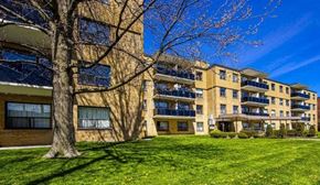 North York apartment for rent - Apartment building with a tree in front of it.