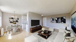 North York apartment for rent - A living room with a white couch, a coffee table, and a television.