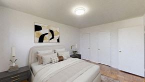 Toronto apartment for rent - A bedroom with a bed, nightstand, and artwork on the wall.