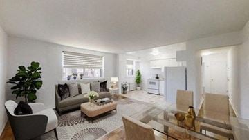 Toronto apartment for rent - A modern living room with a glass table and a grey sofa.