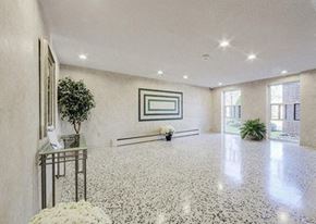 North York apartment for rent - A spacious room with a marble floor and a framed picture on the wall.