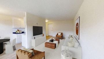 North York apartment for rent - A living room with a white couch and a television.