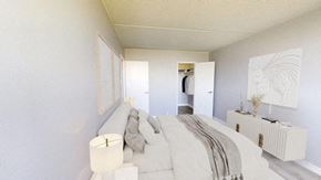 East York apartment for rent - A white bedroom with a bed and a lamp.