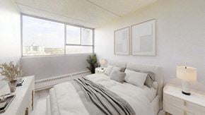 East York apartment for rent - A white bedroom with a large bed and a window overlooking a cityscape.