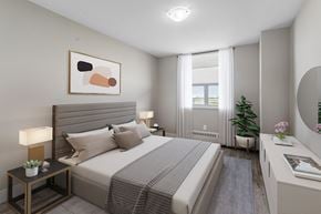 North York apartment for rent - A well-lit bedroom with a large bed and a painting on the wall.