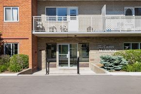 Richmond Hill apartment for rent - A red brick building with a balcony and a glass door.