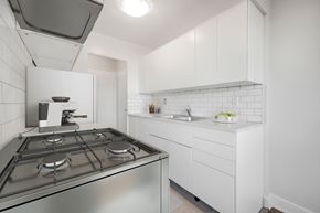 Richmond Hill apartment for rent - A modern kitchen with a stainless steel stove and white cabinets.