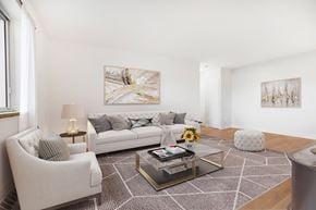 Richmond Hill apartment for rent - A living room with a white couch, a coffee table, and two chairs.