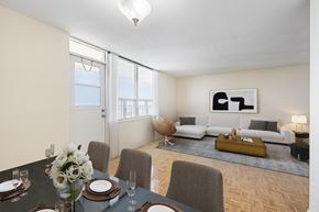 Mississauga apartment for rent - A dining room with a table set for two and a couch in the background.