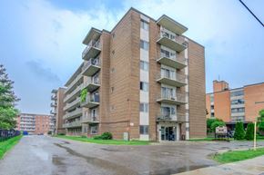 Brampton apartment for rent - A tall apartment building with a flag on the top floor.