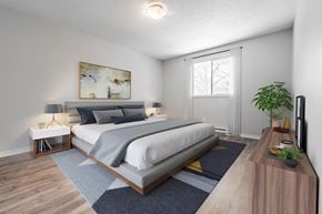 London townhouse for rent - A bedroom with a large bed and a painting on the wall.
