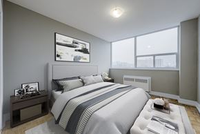North York apartment for rent - A bedroom with a large bed and a picture on the wall.