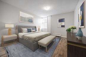 London apartment for rent - A bedroom with a large bed and a bench.