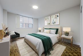 Toronto apartment for rent - A bedroom with a large bed and a green blanket.