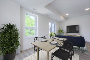 Waterloo apartment for rent - A dining room with a table set for two and a couch in the background.