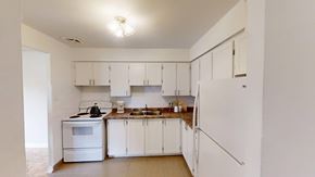 Orangeville apartment for rent - A kitchen with white appliances and cabinets.