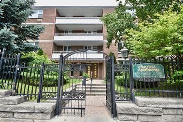 Barrie apartment for rent - The image shows the entrance to Bayfield Apartments with a sign that reads "Affordable Luxury."