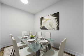 Toronto apartment for rent - A dining room with a glass table and chairs and a painting on the wall.