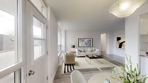 Toronto apartment for rent - A white living room with a couch, chairs, and a coffee table.