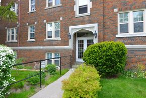 Toronto apartment for rent - A red brick building with a white door and windows.