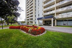 Thornhill apartment for rent - A flower bed in front of a building with the sign "110".