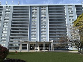North York apartment for rent - A large grey building with a lot of windows and balconies.