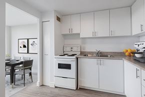 Lindsay apartment for rent - A kitchen with white appliances and cabinets.