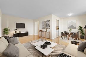 Toronto apartment for rent - A modern living room with a white couch, a coffee table, and a television.