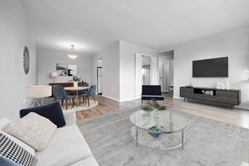 London apartment for rent - A modern living room with a glass coffee table and a white sofa.