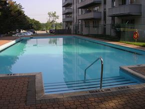 North York apartment for rent - A swimming pool with a warning sign that says shallow area.