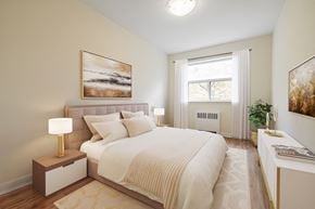 North York apartment for rent - A bedroom with a large bed and a painting on the wall.