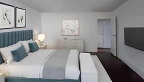 Toronto apartment for rent - A bedroom with two beds, a nightstand, and a dresser.