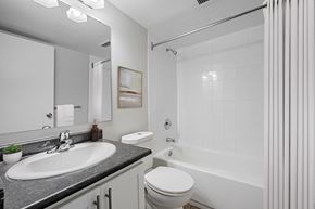 London apartment for rent - A white bathroom with a sink, toilet, and bathtub.