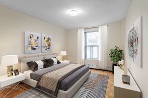 Toronto apartment for rent - A bedroom with a large bed and two lamps.