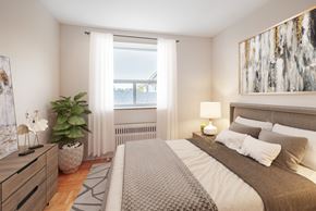 Toronto apartment for rent - A bedroom with a large bed, a potted plant, and a painting on the wall.