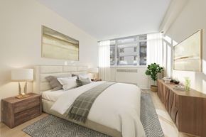 Etobicoke apartment for rent - A bedroom with a large bed and a lamp on a side table.