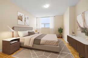 North York apartment for rent - A bedroom with a large bed and a plant on the side table.