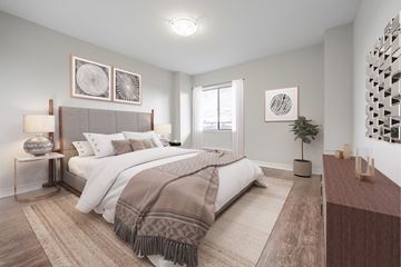London apartment for rent - A bedroom with a large bed and a lamp on the side table.