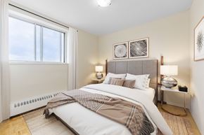 Brampton apartment for rent - A bedroom with a large bed and a window.