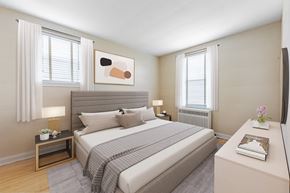North York apartment for rent - A bedroom with a large bed and a painting above it.