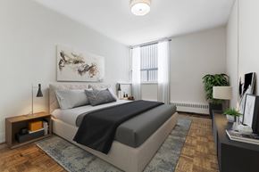 North York apartment for rent - A bedroom with a large bed and a painting on the wall.