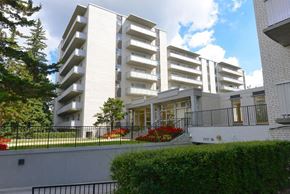 North York apartment for rent - A white building with balconies and a black railing.