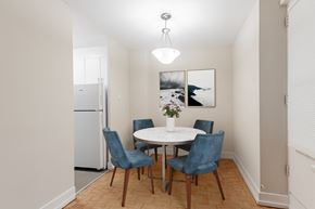 North York apartment for rent - A dining room with a white table and blue chairs.