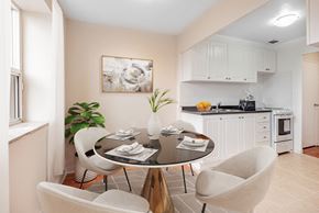 Toronto apartment for rent - A dining room with a table set for two and a plant on the table.