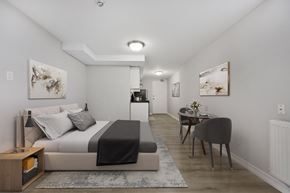 North York apartment for rent - A bedroom with a bed, a chair, and a table.
