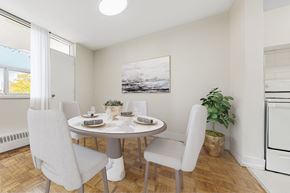 Toronto apartment for rent - A dining room with a table set for two and a potted plant.