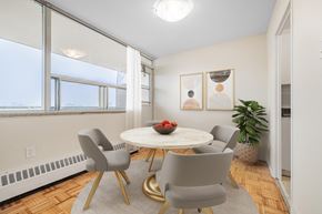 North York apartment for rent - A dining room with a round table and grey chairs.