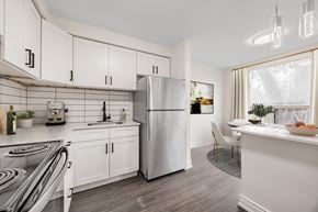Scarborough townhouse for rent - A modern kitchen with white cabinets and a stainless steel refrigerator.