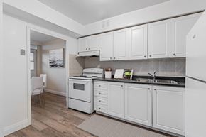North York apartment for rent - A kitchen with white cabinets and a white oven.